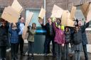 Waving their cardboard waste ready to shred at Barking Riverside