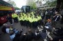Police have made several arrests after protesters blocked a coach set to take asylum seekers to the Bibby Stockholm barge (Yui Mok/PA)