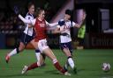 Arsenal's Vivianne Miedema (centre) scores her side's first goal of the game during the Continental Cup match at Meadow Park, London.