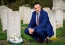 Sanders Draper headteacher Stuart Brooks at the grave of Raimund Sanders Draper at St Andrews Church, Hornchurch