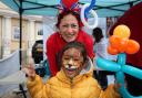 Balloon modeller Lennie Nova poses with a happy customer