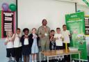 Big Manny with pupils from his former primary school, Henry Green Primary School, in Dagenham
