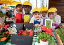 Schoolkids get ready to sell their produce as part of the Young Marketeers programme