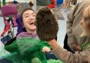A child at Lime Academy Ravensbourne laughs with joy at a puppet. The school has kept its 'good' rating after a recent Ofsted inspection