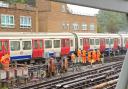 A team of rail workers have been seen standing around a train which is believed to have derailed