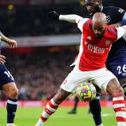 Arsenal's Alexandre Lacazette holds off West Ham United's Arthur Masuaku (right) during the Premier League match at Emirates Stadium