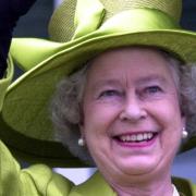 Queen Elizabeth II waves to the crowd at Epsom Downs, 2002