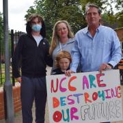 Max Reader (l) was at the protest with his mother Lisa, father Steve (r) and eight-year-old brother James (front).