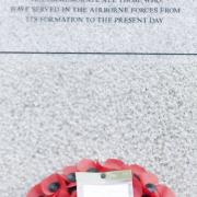 Members of the Ilford 84 branch of the Parachute Regimental Association with their memorial in Coronation Gardens, Romford