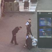 Police attending a man on the floor