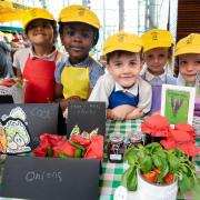 Schoolkids get ready to sell their produce as part of the Young Marketeers programme
