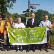Councillors and volunteers celebrate Green Flags at Raphael Park in Romford