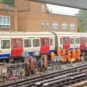 A team of rail workers have been seen standing around a train which is believed to have derailed