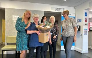 Cathy (left of centre), an NHS nurse for 60 years, saying her goodbyes on her last day at Upminster Medical Centre.