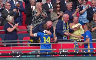 An emotional Steve Gardener hugs Romford captain Kris Newby at Wembley