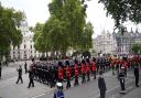 Members of the Royal Navy pull the State Gun Carriage carrying the coffin of Queen Elizabeth II, draped in the Royal Standard with the Imperial State Crown and the Sovereign's orb and sceptre, in the Ceremonial Procession during her State Funeral at