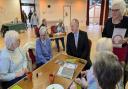 Cllr Ray Morgon speaks with residents at the New Windmill Hall warm space in Upminster