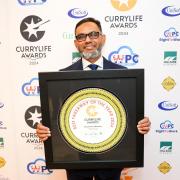 Clay Oven owner Millul Chowdhury celebrates winning the best takeaway award for the second year running