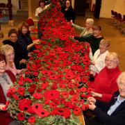 The poppies knitted by the community were sewn on to netting by church members