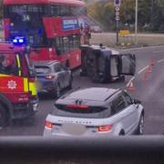 Car tipped to side in A406 crash - live