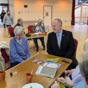 Cllr Ray Morgon speaks with residents at the New Windmill Hall warm space in Upminster