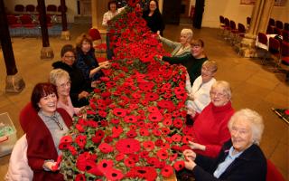 The poppies knitted by the community were sewn on to netting by church members